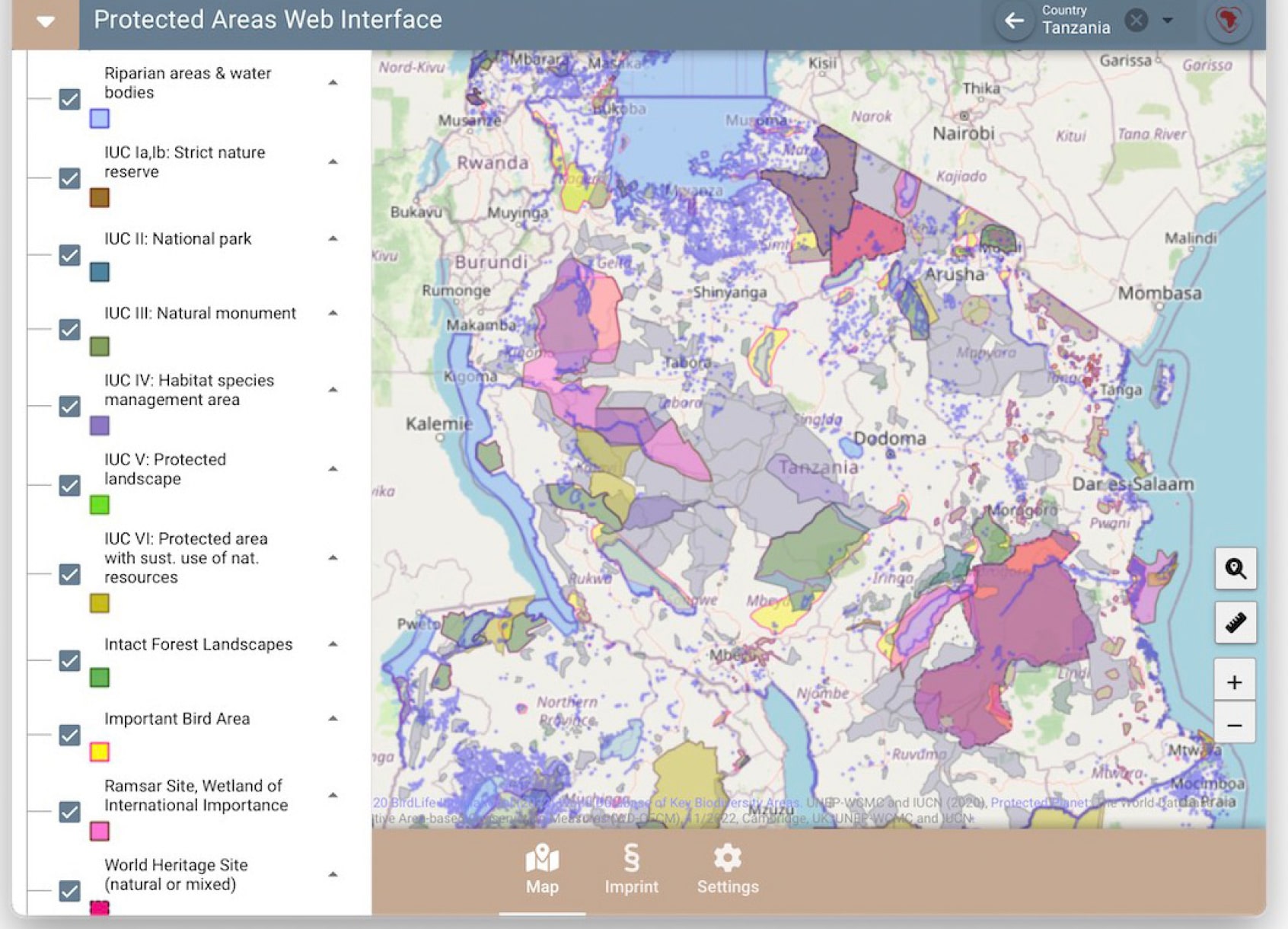 A map interface displaying protected areas in Tanzania, including national parks, nature reserves, and important bird areas, with color-coded regions for conservation types.