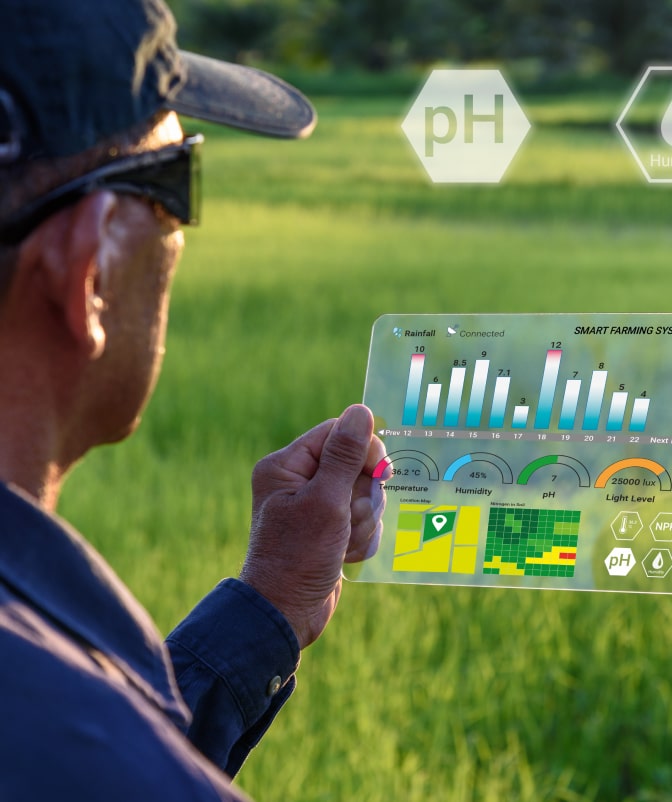 Farmer analyzing agricultural data on a transparent digital screen, displaying pH levels, humidity, and crop insights